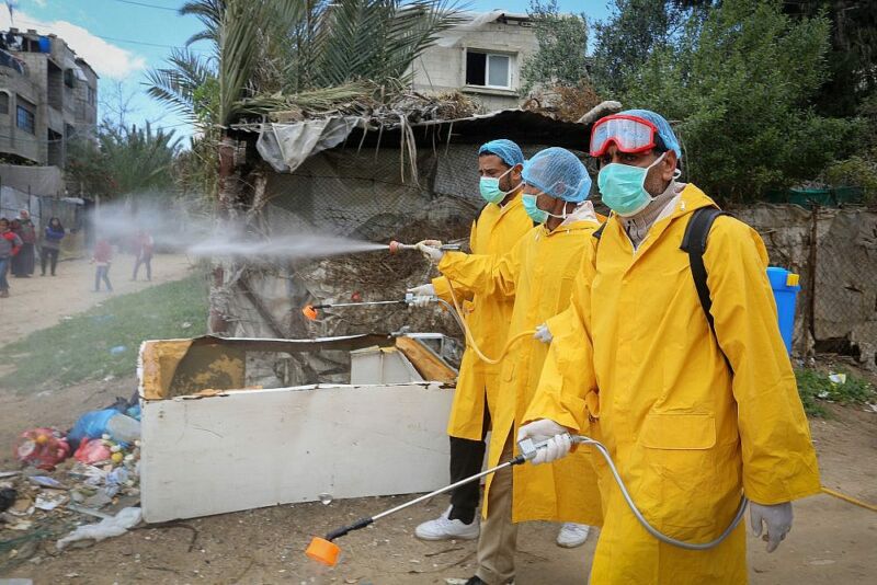 As coronavirus crisis looms, Israelis launch Gaza solidarity campaign. Palestinian health workers spray disinfectant as a precaution against the new coronavirus, in Rafah, southern Gaza Strip, on March 22, 2020. (Abed Rahim Khatib/Flash90)