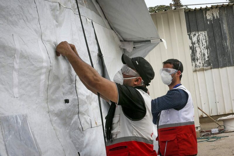 Palestinian health workers set up tents for medical examination of suspected coronavirus patients at the Rafah border crossing with Egypt in the southern Gaza Strip on March 12, 2020. (Abed Rahim Khatib/Flash90)